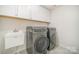 Laundry room featuring washer, dryer, sink, white shaker cabinetry and recessed lighting at 4604 Howie Ln, Harrisburg, NC 28075