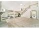 Open-concept living room featuring high ceilings, fireplace, and seamless transition to a modern kitchen area at 4604 Howie Ln, Harrisburg, NC 28075