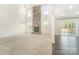 Spacious living area with a stone fireplace, tall windows, and access to the deck at 4604 Howie Ln, Harrisburg, NC 28075