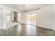 Open living area with deck access, stone fireplace, and plenty of natural light at 4604 Howie Ln, Harrisburg, NC 28075