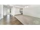 Spacious living room showcasing wood and carpet flooring with modern chandelier lighting at 4604 Howie Ln, Harrisburg, NC 28075