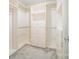 Spacious walk-in closet with carpet and custom built-in shelving, ensuring optimal organization at 4604 Howie Ln, Harrisburg, NC 28075