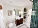 Elegant bathroom featuring a dark wood vanity, arched shelving, updated fixtures, and modern finishes at 5057 Murrayhill Rd, Charlotte, NC 28210