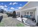 View of the backyard with covered porch and patio area at 52194 Longspur Ln, Fort Mill, SC 29707