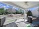 Covered back patio with stone flooring overlooks the backyard at 52194 Longspur Ln, Fort Mill, SC 29707