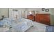 Spacious bedroom featuring soft carpet, a dresser, and ensuite bathroom at 52194 Longspur Ln, Fort Mill, SC 29707