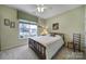 Cozy bedroom featuring a white comforter, natural light, and neutral colored walls at 52194 Longspur Ln, Fort Mill, SC 29707