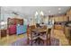 Dining area with a chandelier, hardwood floors, and views into the kitchen and living room at 52194 Longspur Ln, Fort Mill, SC 29707