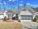 Charming single-story home featuring neutral siding, well-maintained landscaping and an attached two car garage at 52194 Longspur Ln, Fort Mill, SC 29707