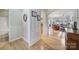 Hallway with hardwood floors, opening to the living room with neutral paint, and white trim at 52194 Longspur Ln, Fort Mill, SC 29707