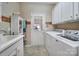 Bright laundry room features tile flooring, washer, dryer and storage at 52194 Longspur Ln, Fort Mill, SC 29707