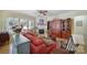 Spacious living room featuring a fireplace, hardwood floors, shutters, and built in shelving at 52194 Longspur Ln, Fort Mill, SC 29707