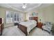 Inviting main bedroom with tray ceiling, neutral carpet and shuttered windows at 52194 Longspur Ln, Fort Mill, SC 29707