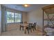 Dining room with a wooden table, four chairs, and a large window at 5235 Reedy Ridge Rd, Charlotte, NC 28215