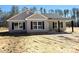 Charming single-story home featuring gray siding, black shutters, and a covered porch at 553 Wateree St, Lancaster, SC 29720