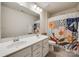 Bathroom features a double vanity and decorative shower curtain at 646 Kahana River Rd, Fort Mill, SC 29715