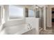Bathroom features a separate tub and shower with gray tile at 646 Kahana River Rd, Fort Mill, SC 29715