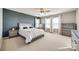 Spacious bedroom features dark accent wall, a large bed, three windows and lots of light at 646 Kahana River Rd, Fort Mill, SC 29715