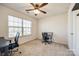 Bright bedroom features a ceiling fan, neutral carpet and walls, and a large window at 646 Kahana River Rd, Fort Mill, SC 29715