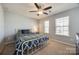 Bedroom with two windows, neutral carpet, and a metal bed frame at 646 Kahana River Rd, Fort Mill, SC 29715