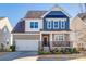 Charming two-story home featuring a mix of siding, stone accents, manicured landscaping, and a two-car garage at 646 Kahana River Rd, Fort Mill, SC 29715
