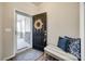 Welcoming foyer with a decorative wreath on the front door, a bench with pillows, and stylish rug at 646 Kahana River Rd, Fort Mill, SC 29715