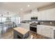 Bright and open kitchen with stainless steel appliances, white cabinets, butcher block island, and hardwood floors at 646 Kahana River Rd, Fort Mill, SC 29715