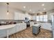 Spacious kitchen features white cabinets, stainless steel appliances, gray backsplash, and center island at 646 Kahana River Rd, Fort Mill, SC 29715
