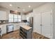 Bright kitchen featuring stainless steel appliances, white cabinets, butcher block island, and pantry at 646 Kahana River Rd, Fort Mill, SC 29715
