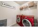 Laundry room featuring a set of red washer and dryer at 646 Kahana River Rd, Fort Mill, SC 29715