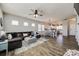 Open-concept living room with a large sectional, seamlessly flowing into the dining and kitchen areas at 646 Kahana River Rd, Fort Mill, SC 29715