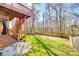 A backyard view with a deck staircase and fenced yard with green grass at 8315 Bridgegate Dr, Huntersville, NC 28078