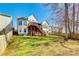 A full backyard view with a deck, stairs, green lawn, and wood fence at 8315 Bridgegate Dr, Huntersville, NC 28078