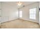 Cozy bedroom with neutral carpet, ceiling fan and natural light from two windows at 8315 Bridgegate Dr, Huntersville, NC 28078