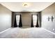 Cozy living room featuring two windows with curtains and a mounted TV bracket at 8315 Bridgegate Dr, Huntersville, NC 28078