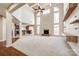 Expansive living room featuring a fireplace, soaring ceilings, and large windows at 8315 Bridgegate Dr, Huntersville, NC 28078