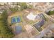 Aerial view of a community pool, tennis courts, playground and parking lot at 9138 Babbitt Way, Charlotte, NC 28216