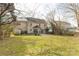 The backyard features a large grassy area and is accented by a patio area adjacent to the home at 9138 Babbitt Way, Charlotte, NC 28216