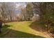 The large, grassy backyard offers plenty of space for activities and backs to a wooded area at 9138 Babbitt Way, Charlotte, NC 28216