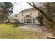 A view of the home's rear exterior shows the large backyard and a patio area at 9138 Babbitt Way, Charlotte, NC 28216
