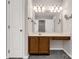 Bathroom featuring a single sink vanity with dark wood cabinets and a large mirror with vanity lighting at 9138 Babbitt Way, Charlotte, NC 28216