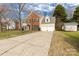 Traditional two-story home with attached two-car garage and long driveway offering ample parking space at 9138 Babbitt Way, Charlotte, NC 28216
