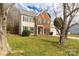 Charming two-story home featuring brick accents and green shutters, complemented by a well-maintained lawn at 9138 Babbitt Way, Charlotte, NC 28216
