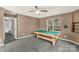 Spacious game room features a pool table, natural light, and neutral carpet at 9138 Babbitt Way, Charlotte, NC 28216