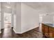 Hallway with tile flooring leading into a living area with hardwood floors and natural light at 9138 Babbitt Way, Charlotte, NC 28216