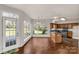 Eat-in kitchen with wood floors, stainless steel appliances, wood cabinets, and a window overlooking the backyard at 9138 Babbitt Way, Charlotte, NC 28216