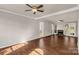 Spacious living room featuring hardwood floors, a fireplace, and large windows for natural light at 9138 Babbitt Way, Charlotte, NC 28216