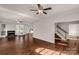 Open living room featuring hardwood floors, a fireplace, and abundant natural light from large windows at 9138 Babbitt Way, Charlotte, NC 28216
