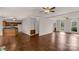 Spacious living area with hardwood floors, ceiling fans, and an open layout connecting to the kitchen at 9138 Babbitt Way, Charlotte, NC 28216