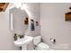 Cozy powder room featuring pedestal sink, decorative mirror and fixtures, and a tiled floor at 9138 Babbitt Way, Charlotte, NC 28216